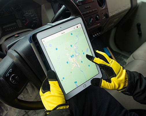 A customer using the GPS fleet tracking system on a tablet to look up vehicle location for one of the assets in their fleet